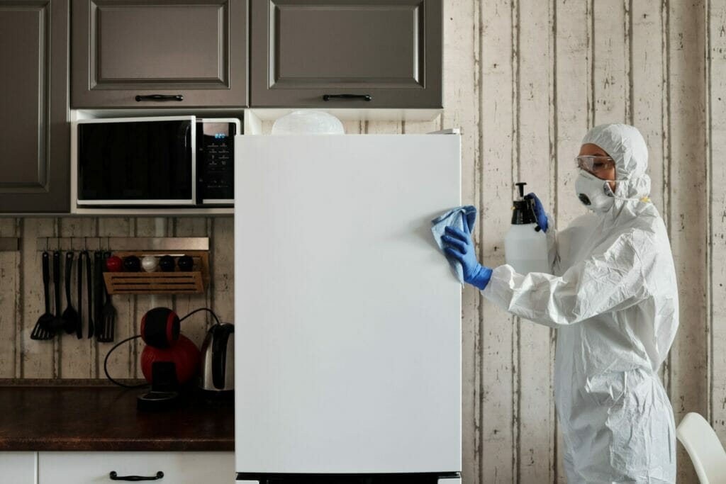 Hazmat man cleaning a fridge - How to clean my kitchen.