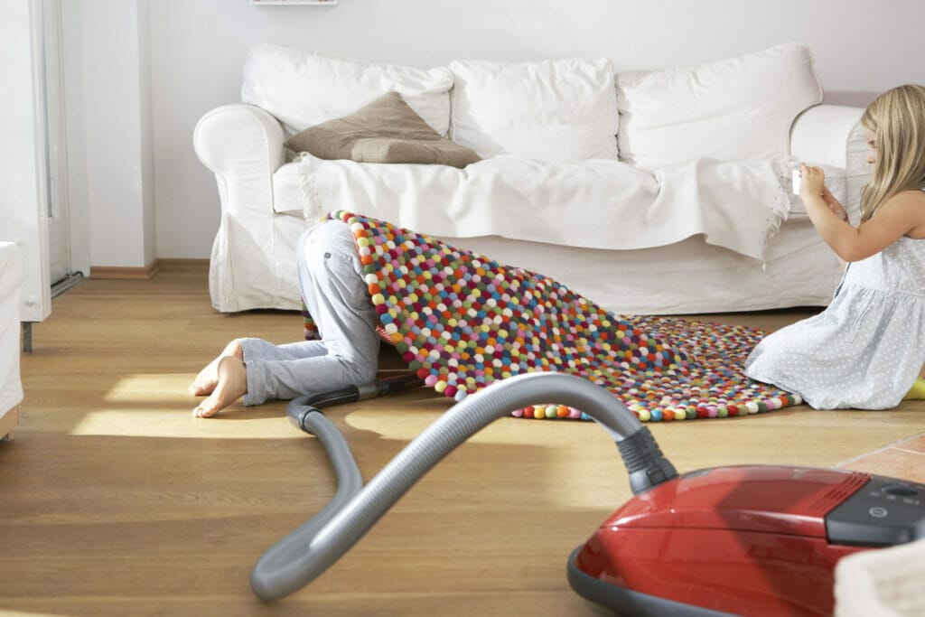 Women vacuuming with her child