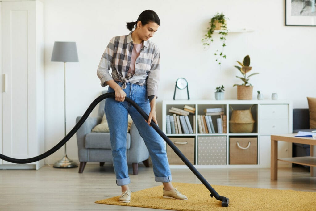 Women vacuuming her carpet
