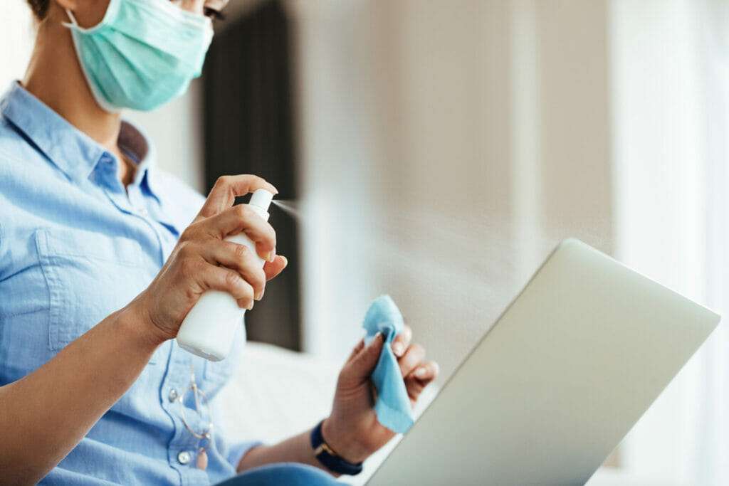 disinfecting the desk and laptop.