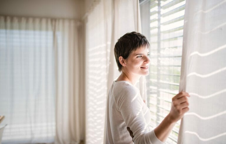 Woman learning how to clean blinds and curtains