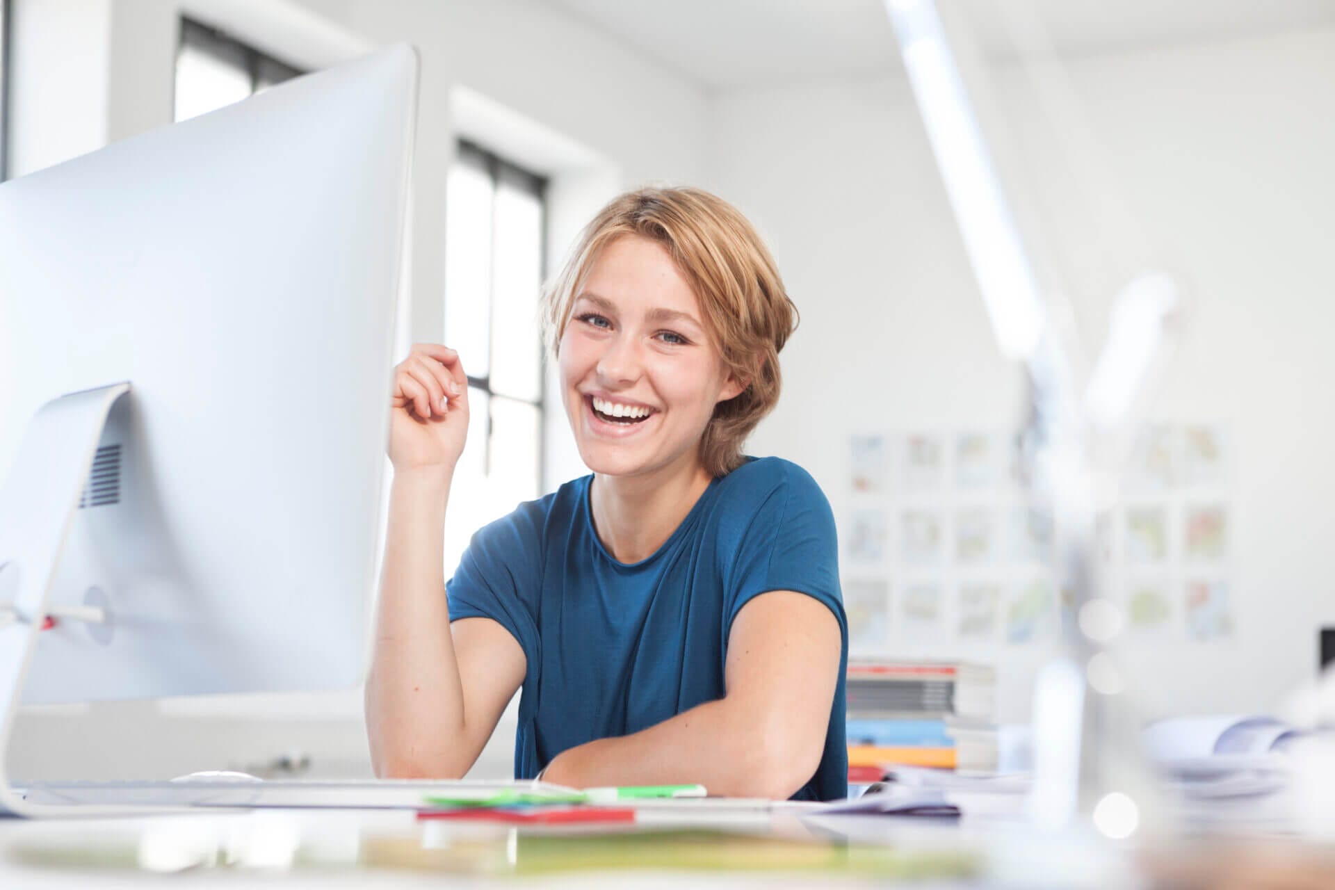 A woman smiling at her office desk