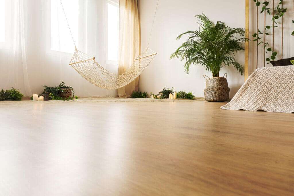 Bedroom with hardwood floors and plants.