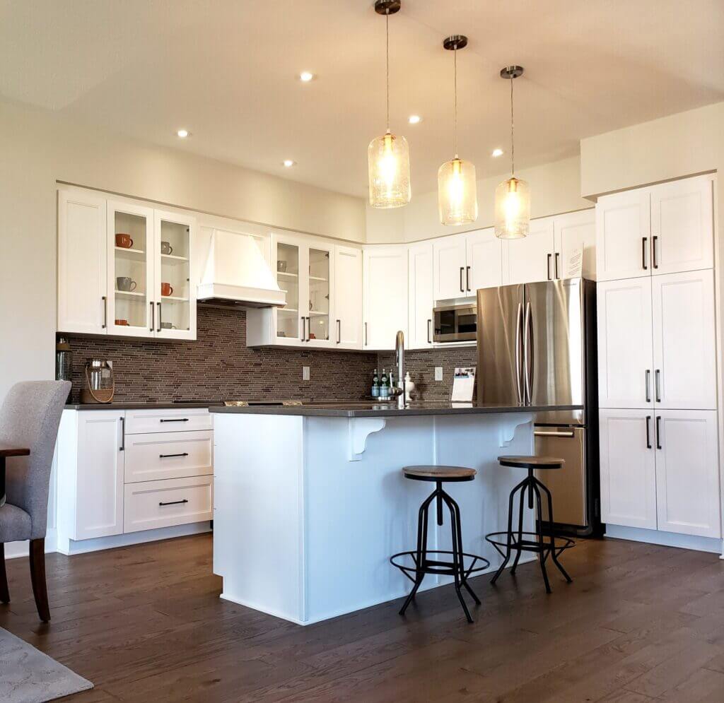 Beautiful illuminated kitchen with hardwood floors.