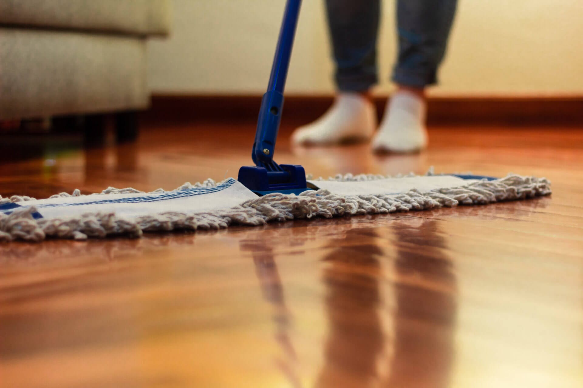 Woman cleaning after learning how to clean prefinished hardwood floors