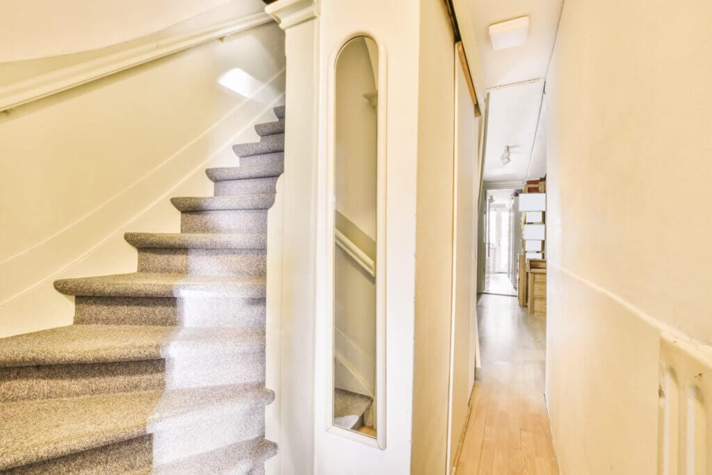 White and grey carpeted stairs in a nice house