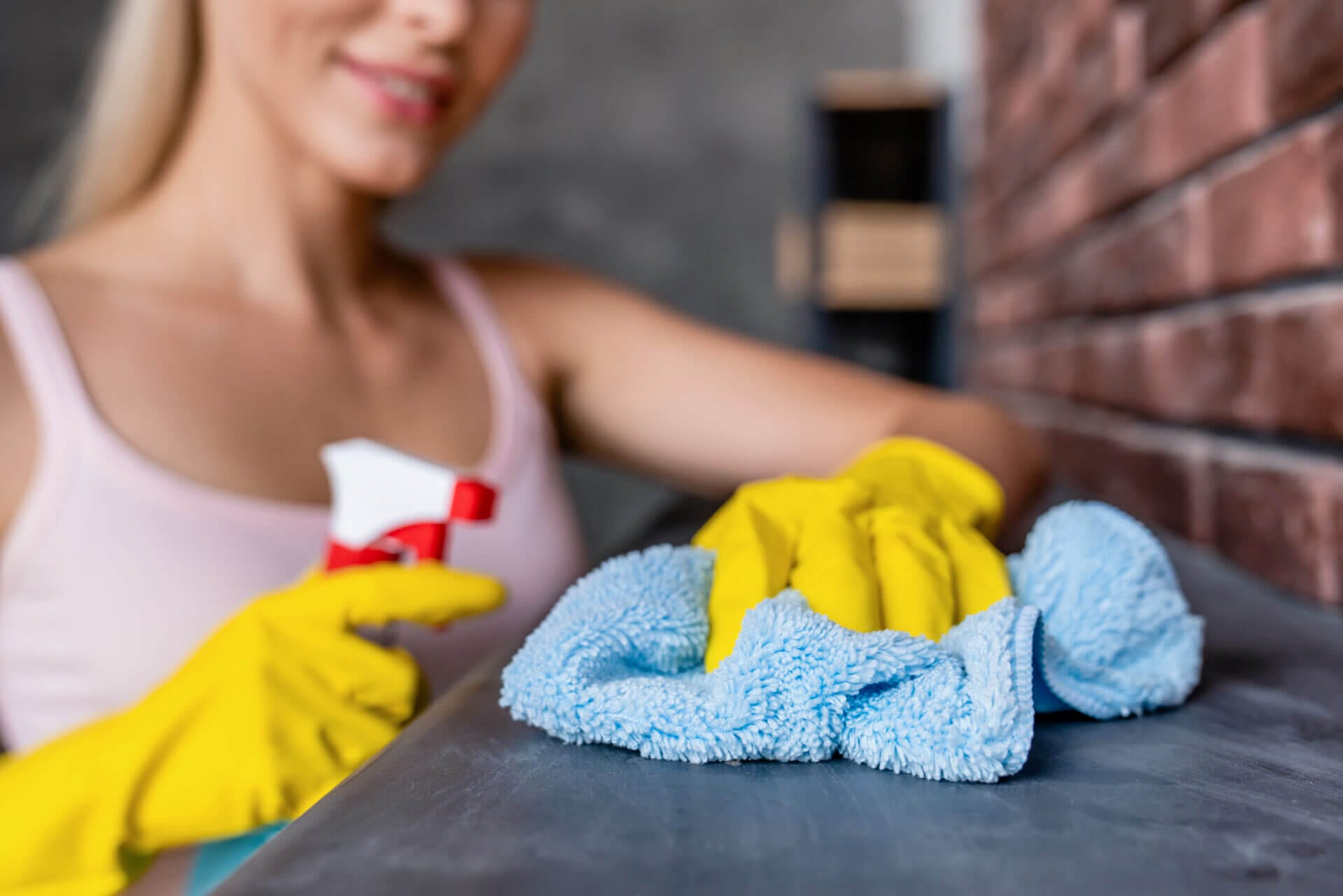 Young woman cleaning her house without making common cleaning mistakes