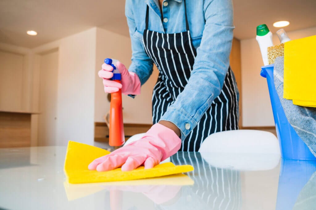 Close up of a man cleaning his house with cleaning products