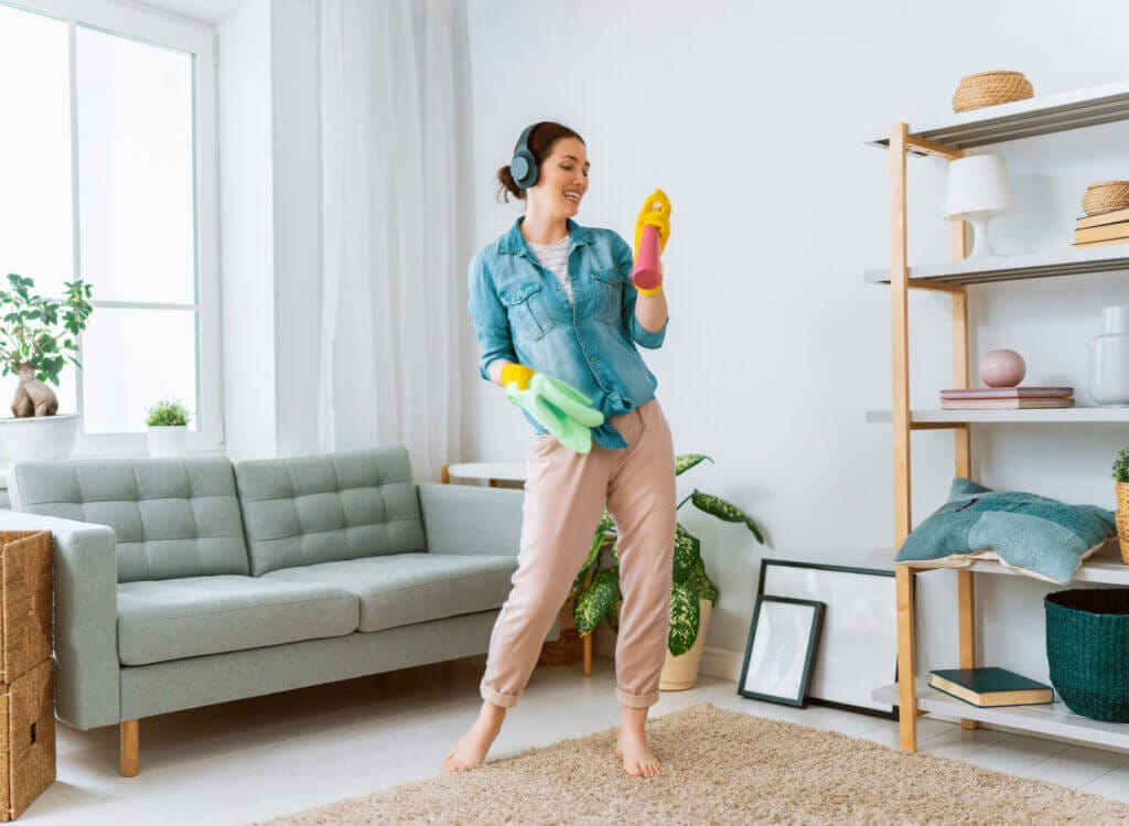 Woman doing her house cleaning while dancing 