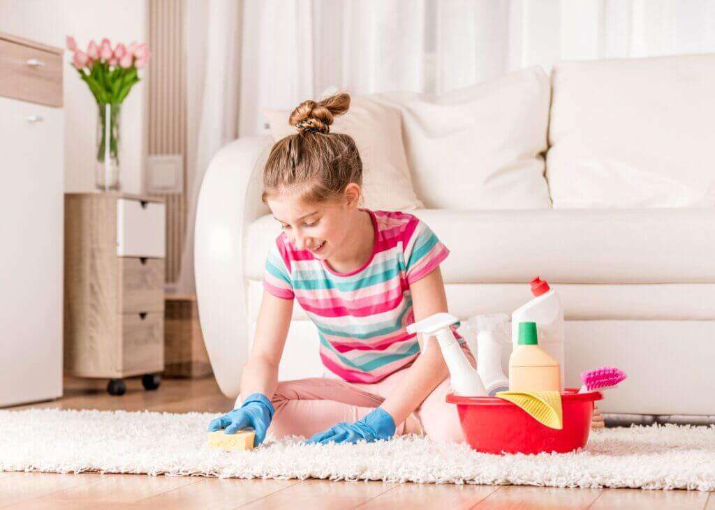 A person vacuuming their rug after learning how to keep carpet clean in high traffic areas