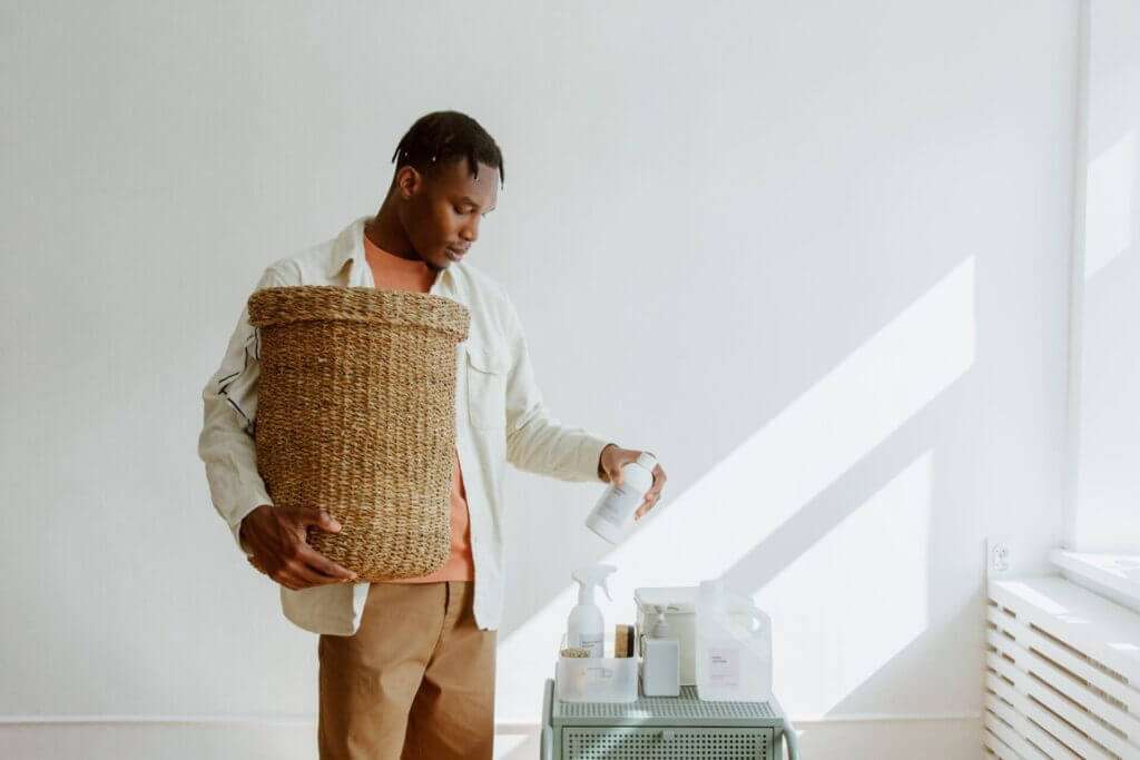 A person gathering cleaning supplies after learning how to deep clean carpet without machine